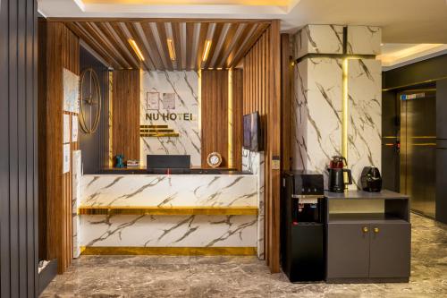 a lobby with white marble walls and a counter at Sultanahmet Nu Hotel in Istanbul