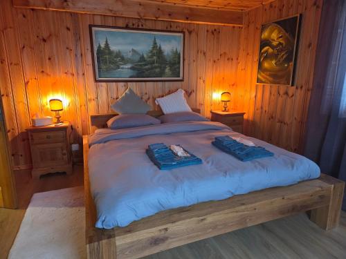 a bedroom with a large bed with two towels on it at Duplex Salgesch in Salgesch