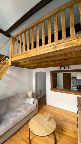 a living room with a couch and a staircase at Studio in Saint-Martin-Vésubie