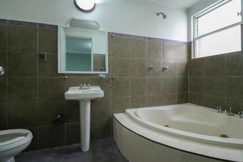 a bathroom with a sink and a tub and a toilet at Hotel Real Santa Rosa in Morelia
