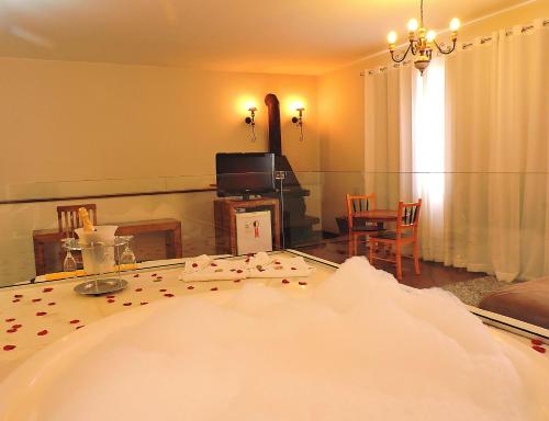 a living room with a large tub with a mirror at Pousada Ouro de Minas in Tiradentes