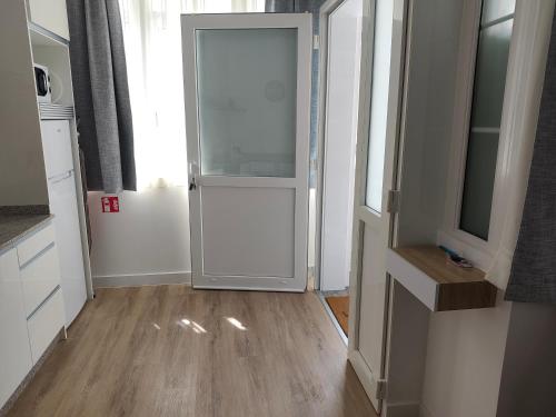 an open door in a room with a kitchen at apartamentos YEIK in Muxia