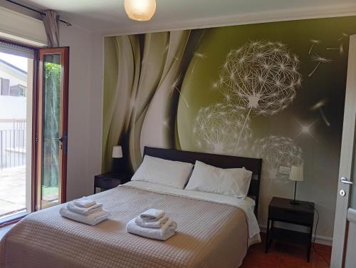 a bedroom with a bed with two towels on it at Mimì Home in Isernia