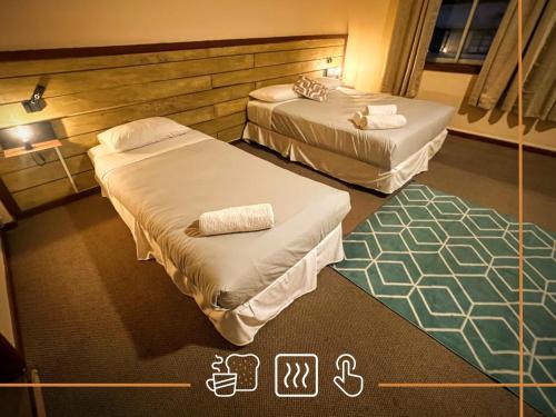 a hotel room with two beds in a room at Noth Central in Osorno