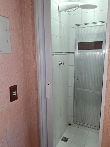 a bathroom with a shower with a glass door at LOFT da Serra Imperial in Petrópolis