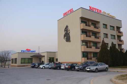 a hotel with cars parked in a parking lot at Hotel Sveti Nikola in Sliven