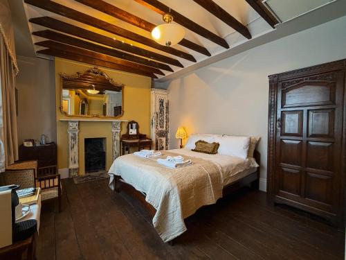 a bedroom with a large bed and a mirror at 41 Whitfield Street Hotel in London