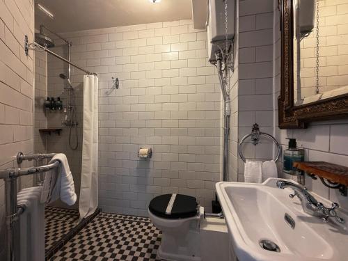 a bathroom with a toilet and a sink at 41 Whitfield Street Hotel in London