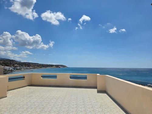a view of the ocean from the balcony of a building at Triton Sea View Studios in Tsoutsouros