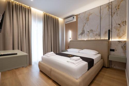 a hotel room with a bed and a window at WG Hotel Lake View in Ksamil