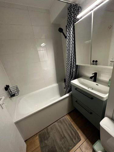 a bathroom with a tub and a sink and a bath tub at Chalet Puy-Saint-Vincent m from slopes in Puy-Saint-Vincent