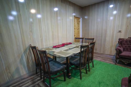 a dining room with a table and some chairs at Royal Brangsa in Skardu