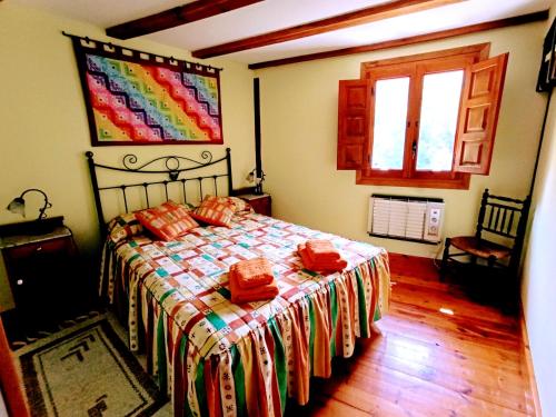 a bedroom with a bed with red pillows on it at Molino De Pradillo in Pradillo