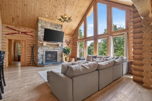 a living room with a couch and a fireplace at Fiddler Lake Resort - Elk 96 in Mille-Isles