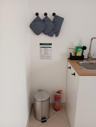 a bathroom with a sink and two moustache hooks at Suite 93 in Mola di Bari