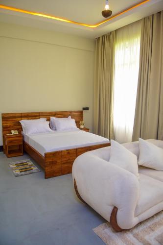 a bedroom with two beds and a couch at N-line Residency Hotel in Arusha