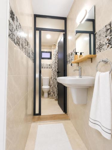 a bathroom with a sink and a toilet at Miramar Surf Anza in Agadir