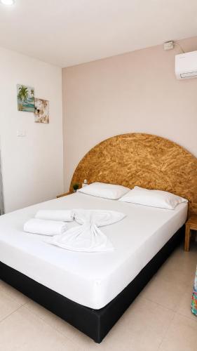 a bedroom with a large white bed in a room at Casa Wilson in Cartagena de Indias