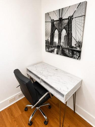 a desk with a chair and a painting on a wall at Convention District Studio - Downtown Houston in Houston