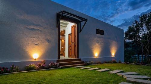 a home with a front door and a grass yard at Ceylon tea resort Ella in Ella