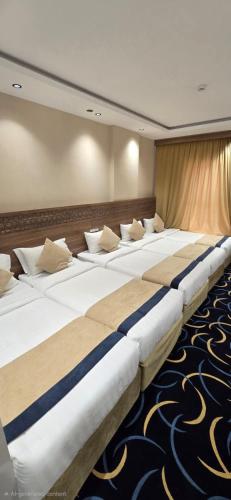 a row of beds sitting in a room at Nuzul Nebras Al Madinah in Medina