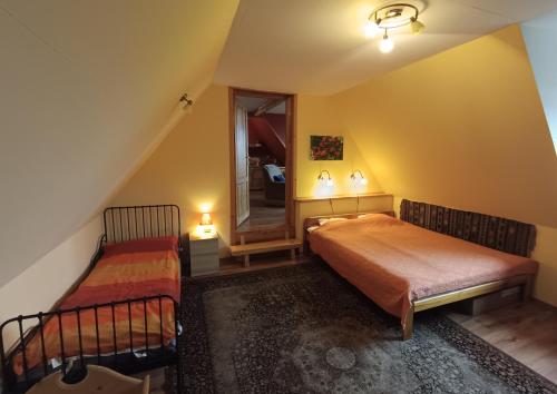 a bedroom with two beds and a mirror at Kitajówka in Bańska Wyżna