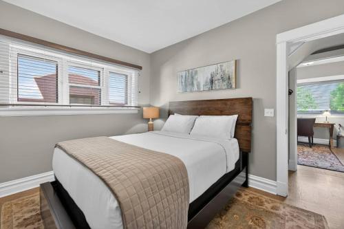 a bedroom with a large bed in a room with windows at Your Chicago Retreat in Chicago