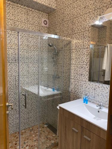 a bathroom with a shower and a sink at Vila das Pétalas in Portimão