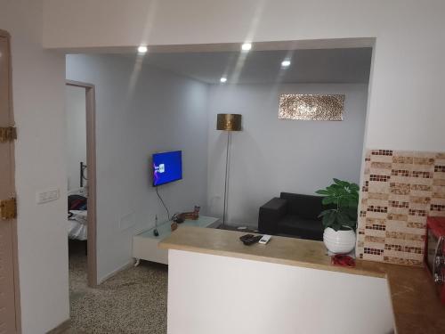 a living room with a table and a couch at Studio in La Goulette