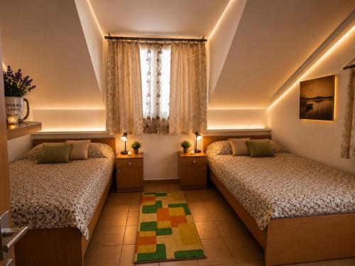 a bedroom with two beds and a window at Apartments Maja in Star Dojran