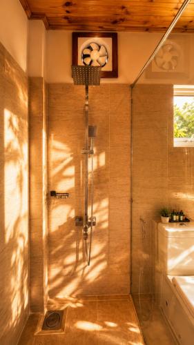 a shower with a glass door in a bathroom at Greenland Villa Ella in Ella