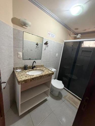 a bathroom with a sink and a toilet and a shower at Pousada Pérola do Mar in Tamandaré