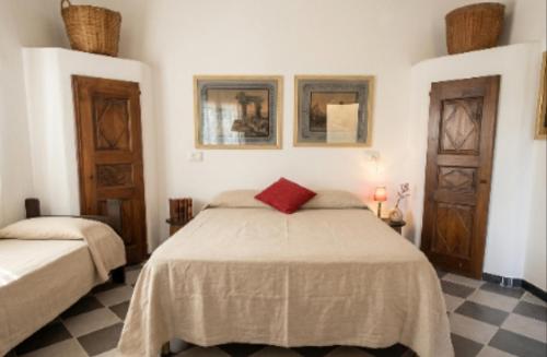 a bedroom with a bed with a red pillow on it at Authentic and Charming apartments between Cinque Terre and Portofino - Velva House in Velva