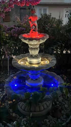 a fountain with a statue of a woman on it at Villa Bosotina Royal Sea View in Kukljica