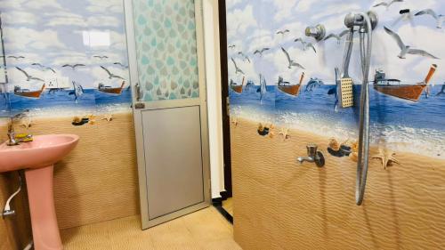 a bathroom with a shower and a sink and birds at Nilaveli Beach Haven in Nilaveli