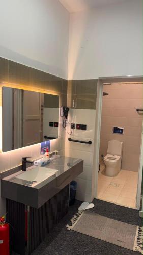 a bathroom with a sink and a toilet at Sweet Sbah in Hail
