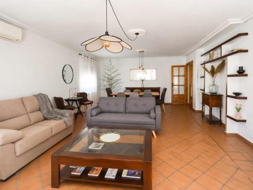 a living room with a couch and a table at El encinar de las nieves - Piscina privada, cerca de Toledo y Puy du Fou in Toledo