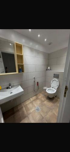 a bathroom with a toilet and a sink at rahamni stays in Cheraga