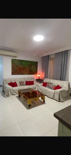 a living room with two couches and a coffee table at rahamni stays in Cheraga
