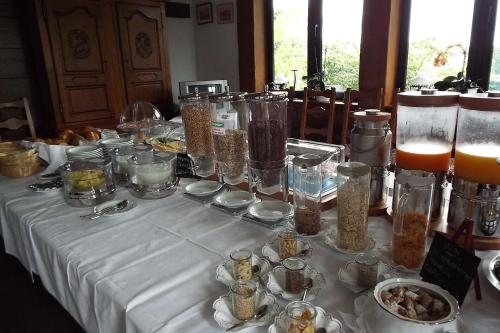 a table with a white table cloth with food on it at Park-Hotel in Bad Hönningen