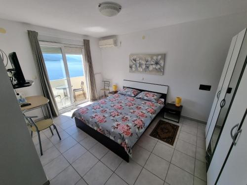 a bedroom with a bed with a view of the ocean at Villa Kanata in Povile