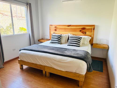 a bedroom with a large bed with two pillows at Estudio con Terraza in Todos Santos