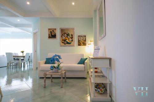 a living room with a white couch and a table at Victory's Luxury House with Jacuzzi on the Roof in Casamicciola Terme