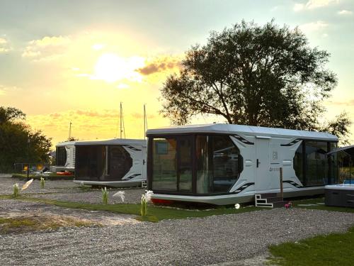 a group of rvs parked in a parking lot at Futuristic Capsule - Private Jacuzzi & Beach access in Wapnica