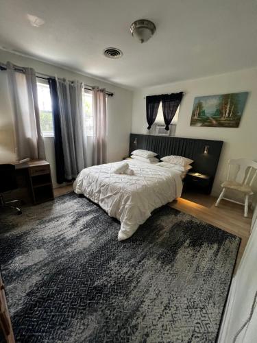 a bedroom with a large bed and a rug at Miami Drip Star Life Resort in Parkway Regional Medical Center Heliport