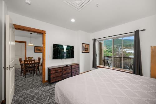 a bedroom with a bed and a television and a table at Morning Star Lodge - Hosted by Linda in Kellogg