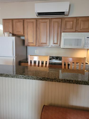 a kitchen with wooden cabinets and a counter top at Atlantis Inn in Rehoboth Beach