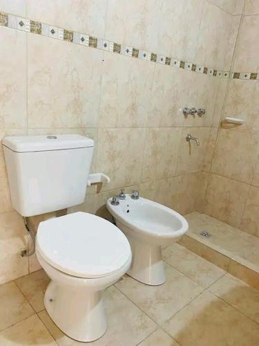 a bathroom with a toilet and a sink at Los Bajitos in Maipú