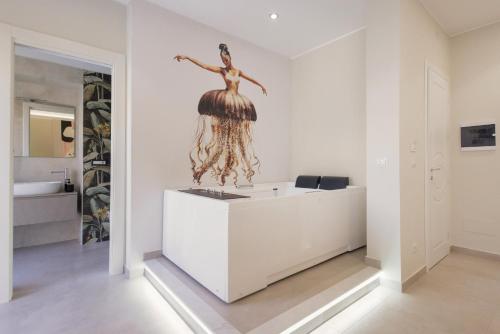 a bathroom with a mermaid statue on the wall at BellDuomo Suite Messina in Messina