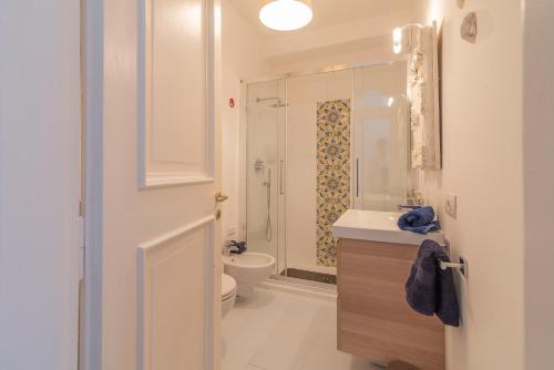 a bathroom with a toilet and a sink and a shower at Casa vista Faraglioni Capri in Capri